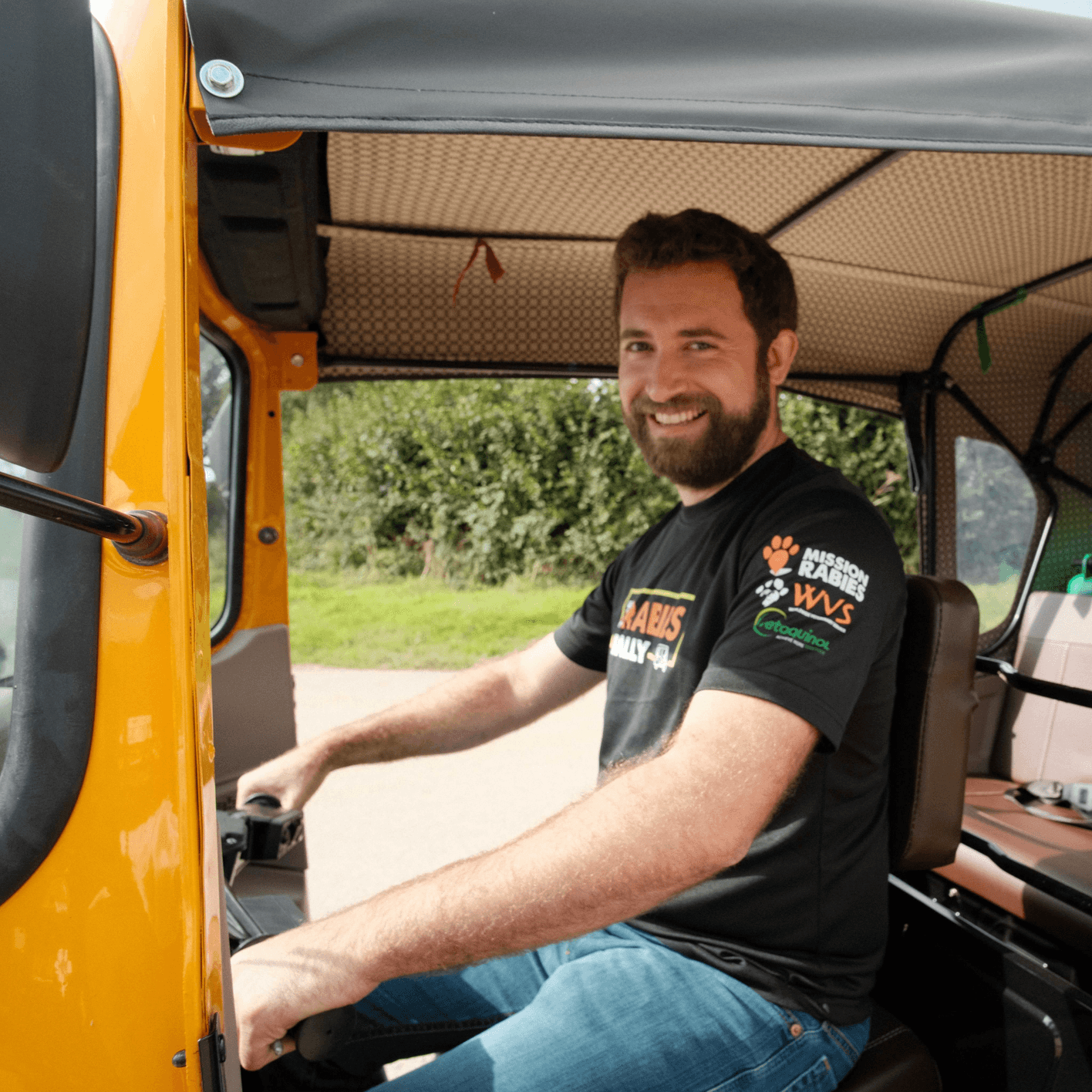 Fred smiling and driving